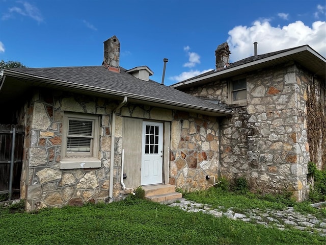 544 N Clinton St, Stephenville, TX 76401 - entrance to property with stone siding, roof with shingles, and a chimney