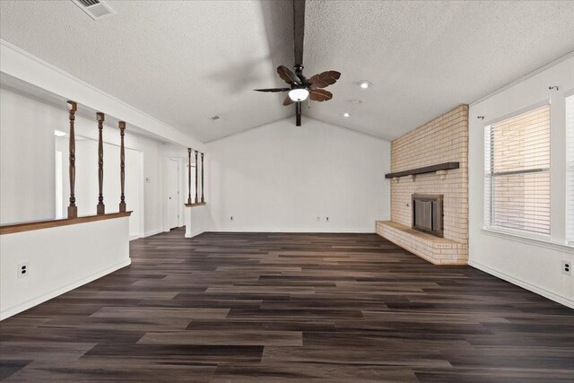 310 Naples Dr, Duncanville, TX 75116 - unfurnished living room featuring ceiling fan, a fireplace, wood finished floors, a textured ceiling, and vaulted ceiling