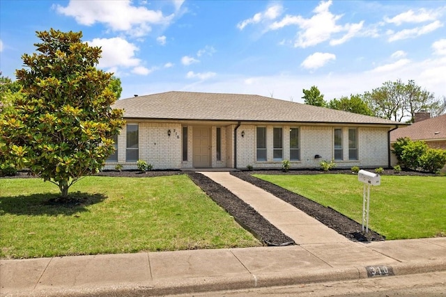 310 Naples Dr, Duncanville, TX 75116 - ranch-style home featuring brick siding, a front yard, and roof with shingles