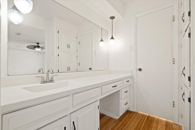 310 Naples Dr, Duncanville, TX 75116 - bathroom featuring wood finished floors, vanity, and a ceiling fan