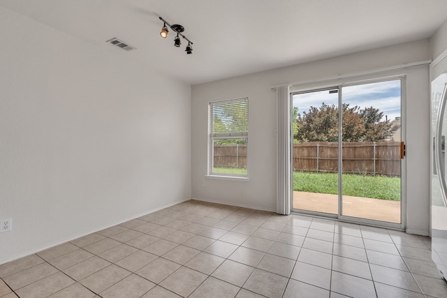 812 Piedmont Dr, Mckinney, TX 75071 - empty room with light tile patterned flooring, rail lighting, and baseboards