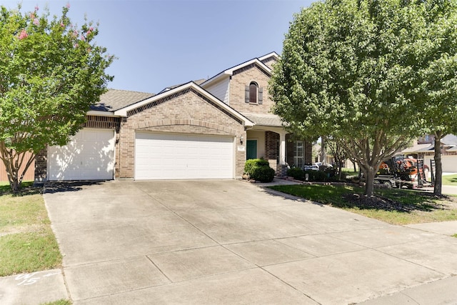 115 Roundup Rd, Waxahachie, TX 75165 - view of front of house featuring brick siding, an attached garage, and driveway