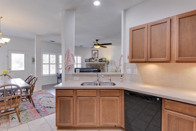 115 Roundup Rd, Waxahachie, TX 75165 - kitchen with dishwasher, a sink, a ceiling fan, decorative backsplash, and healthy amount of natural light