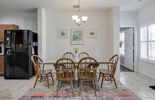 115 Roundup Rd, Waxahachie, TX 75165 - dining room with light tile patterned flooring and a chandelier