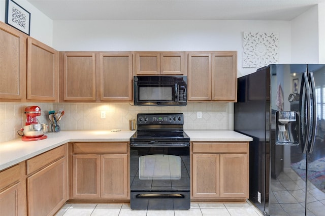 115 Roundup Rd, Waxahachie, TX 75165 - kitchen with black appliances, light countertops, light tile patterned flooring, and backsplash