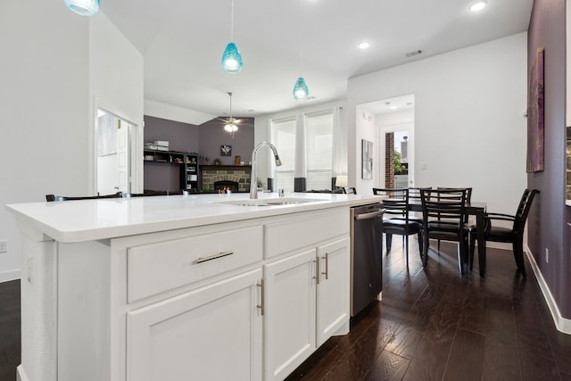 1809 13th St, Argyle, TX 76226 - kitchen featuring dishwasher, a sink, ceiling fan, a stone fireplace, and an island with sink