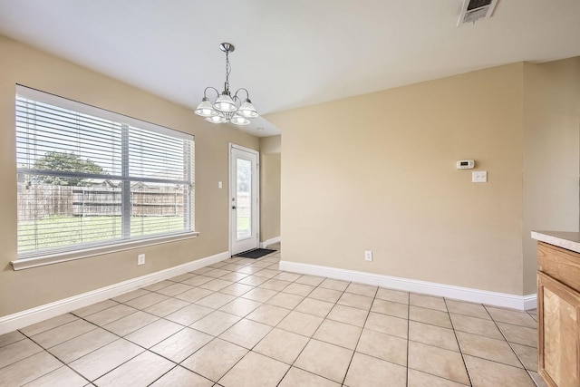 117 Parkview Dr, Saginaw, TX 76179 - unfurnished dining area featuring a chandelier, baseboards, and light tile patterned flooring