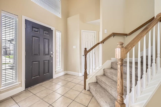 117 Parkview Dr, Saginaw, TX 76179 - entrance foyer featuring baseboards, a towering ceiling, light tile patterned floors, stairs, and healthy amount of natural light