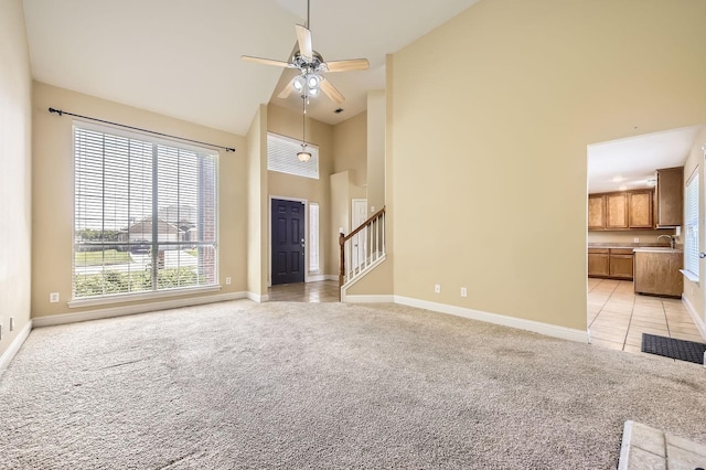 117 Parkview Dr, Saginaw, TX 76179 - unfurnished living room with high vaulted ceiling, light carpet, a sink, ceiling fan, and baseboards