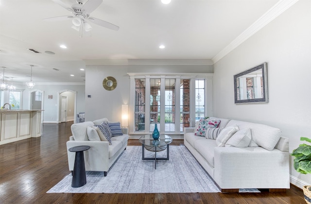 124 Lonesome Trl, Haslet, TX 76052 - living room featuring arched walkways, ornamental molding, a ceiling fan, dark wood finished floors, and baseboards