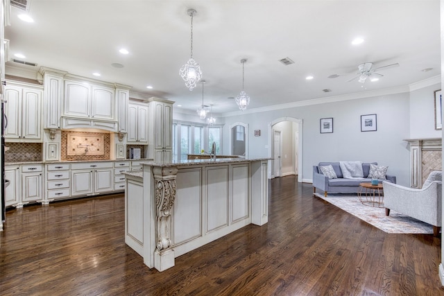 124 Lonesome Trl, Haslet, TX 76052 - kitchen featuring open floor plan, arched walkways, a ceiling fan, dark wood finished floors, and crown molding