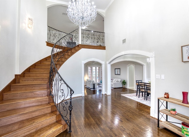 124 Lonesome Trl, Haslet, TX 76052 - stairs with arched walkways, a chandelier, wood finished floors, baseboards, and a towering ceiling
