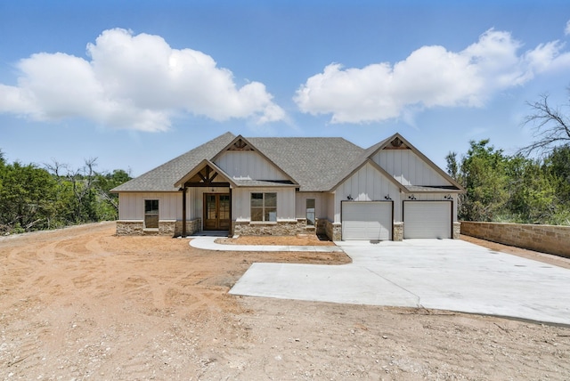550 Blue Marlin Ct, Bluff Dale, TX 76433 - view of front of property with french doors, a garage, roof with shingles, concrete driveway, and stone siding