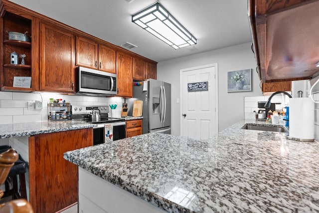 475 Maywood, Woodway, TX 76712 - kitchen featuring stainless steel appliances, tasteful backsplash, light stone counters, and open shelves