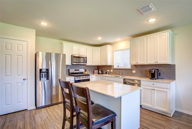 1805 Elderberry St, Royse City, TX 75189 - kitchen with stainless steel appliances, a sink, backsplash, light wood-style floors, and recessed lighting