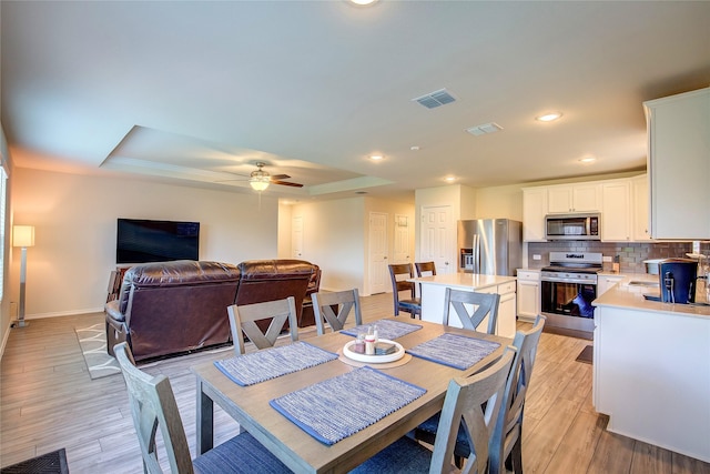 1805 Elderberry St, Royse City, TX 75189 - dining area with a raised ceiling, light wood finished floors, baseboards, recessed lighting, and a ceiling fan