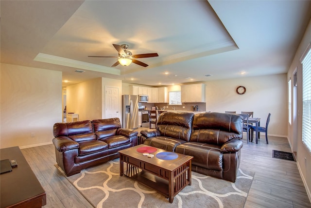 1805 Elderberry St, Royse City, TX 75189 - living room with a tray ceiling, a ceiling fan, light wood-style flooring, baseboards, and ornamental molding