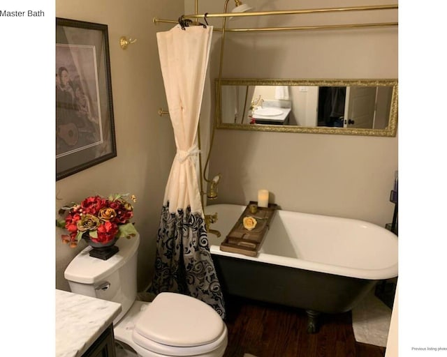 1951 College Ave, Fort Worth, TX 76110 - full bath featuring a freestanding tub, vanity, toilet, and wood finished floors