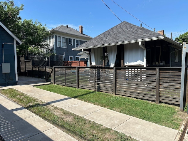 1951 College Ave, Fort Worth, TX 76110 - view of side of property featuring roof with shingles and a chimney