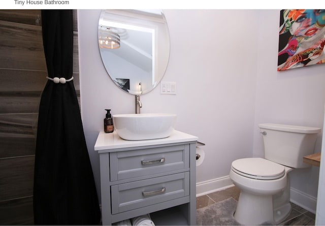 1951 College Ave, Fort Worth, TX 76110 - bathroom featuring baseboards, vanity, toilet, and tile patterned floors