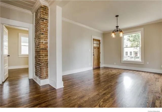 1951 College Ave, Fort Worth, TX 76110 - empty room with healthy amount of natural light, a chandelier, wood finished floors, crown molding, and baseboards
