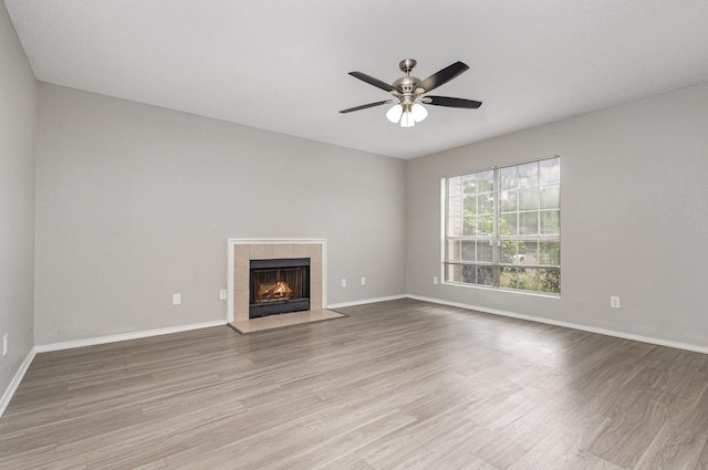 912 Brae Loch Dr, Dallas, TX 75217 - unfurnished living room with wood finished floors, ceiling fan, a fireplace, and baseboards