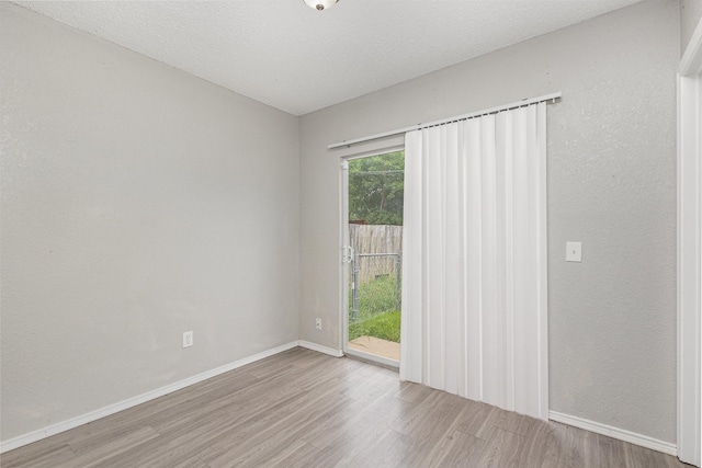 912 Brae Loch Dr, Dallas, TX 75217 - spare room featuring wood finished floors and baseboards