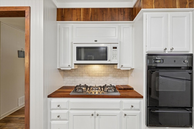 226 Hillcrest St, Sanger, TX 76266 - kitchen with oven, white microwave, a warming drawer, stainless steel gas stovetop, and white cabinets