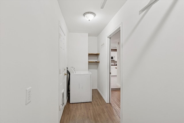 226 Hillcrest St, Sanger, TX 76266 - laundry room featuring light wood-style floors and baseboards