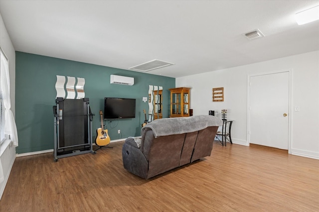 226 Hillcrest St, Sanger, TX 76266 - living area with wood finished floors, a wall mounted air conditioner, and baseboards