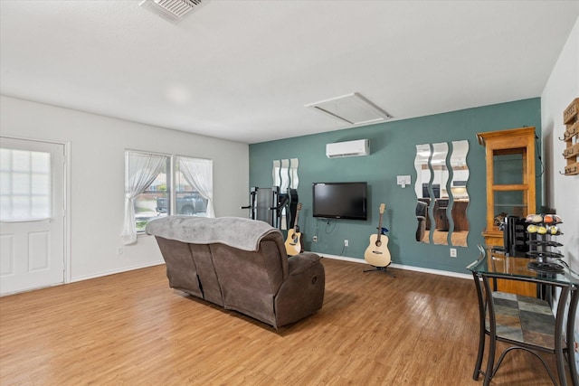 226 Hillcrest St, Sanger, TX 76266 - living room featuring a wall mounted AC, wood finished floors, and baseboards