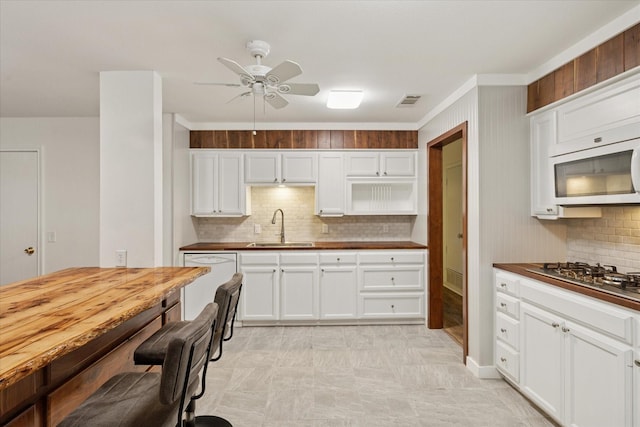 226 Hillcrest St, Sanger, TX 76266 - kitchen featuring a sink, white appliances, backsplash, a ceiling fan, and white cabinets