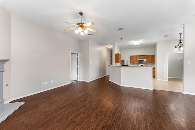 203 Mustang Trl, Celina, TX 75009 - unfurnished living room featuring light wood finished floors, a ceiling fan, and baseboards