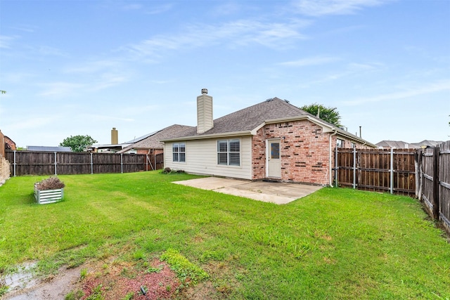 203 Mustang Trl, Celina, TX 75009 - back of house with brick siding, a patio, a chimney, and roof with shingles