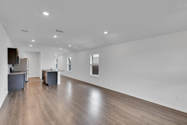 1408 Sebastian Dr, Forney, TX 75126 - unfurnished living room featuring dark wood-type flooring, recessed lighting, and baseboards