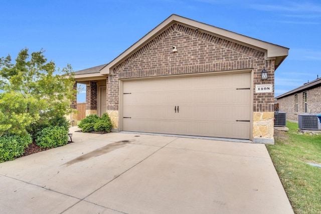 1408 Sebastian Dr, Forney, TX 75126 - view of front of property featuring brick siding, central AC, stone siding, driveway, and an attached garage