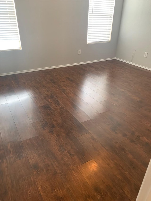 833 San Miguel Trl, Fort Worth, TX 76052 - spare room featuring dark wood-style flooring, baseboards, and plenty of natural light