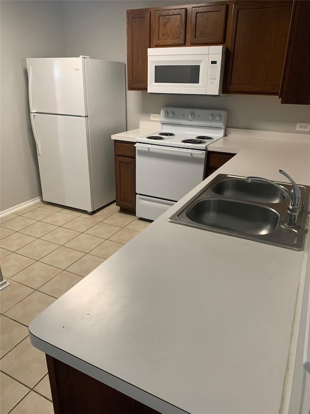 833 San Miguel Trl, Fort Worth, TX 76052 - kitchen featuring white appliances, a sink, light tile patterned floors, and light countertops