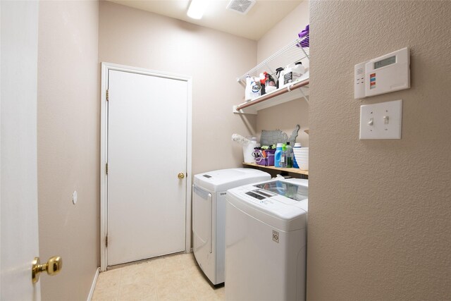 4017 Summerhill Ln, Fort Worth, TX 76244 - laundry area with washer and clothes dryer and light tile patterned floors