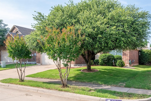 4017 Summerhill Ln, Fort Worth, TX 76244 - obstructed view of property with brick siding, concrete driveway, a front lawn, and an attached garage