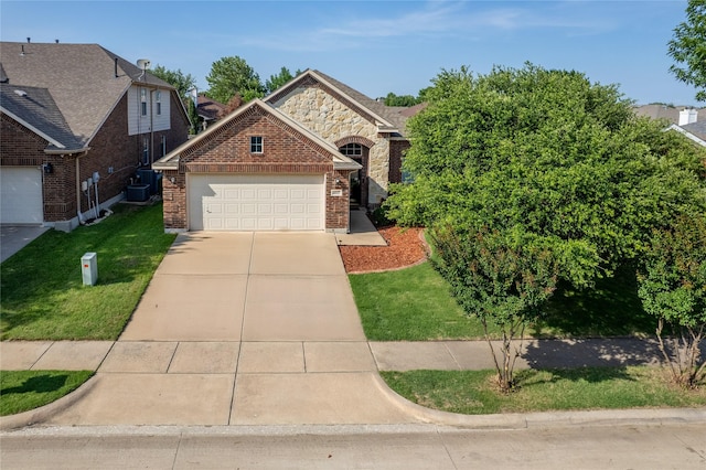 4017 Summerhill Ln, Fort Worth, TX 76244 - view of front of property with brick siding, an attached garage, a front lawn, driveway, and central air condition unit