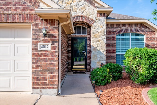 4017 Summerhill Ln, Fort Worth, TX 76244 - view of exterior entry featuring brick siding, an attached garage, stone siding, and roof with shingles