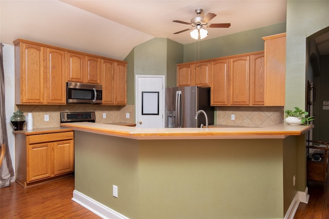 4017 Summerhill Ln, Fort Worth, TX 76244 - kitchen with appliances with stainless steel finishes, dark wood finished floors, light countertops, ceiling fan, and vaulted ceiling