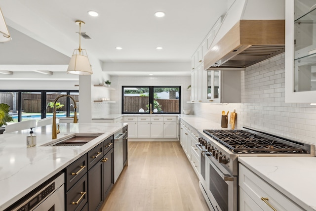 4162 Allencrest Ln, Dallas, TX 75244 - kitchen with high end range, premium range hood, a sink, white cabinets, and recessed lighting