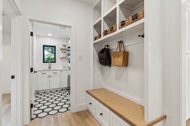 4162 Allencrest Ln, Dallas, TX 75244 - mudroom featuring a sink, light wood finished floors, and baseboards