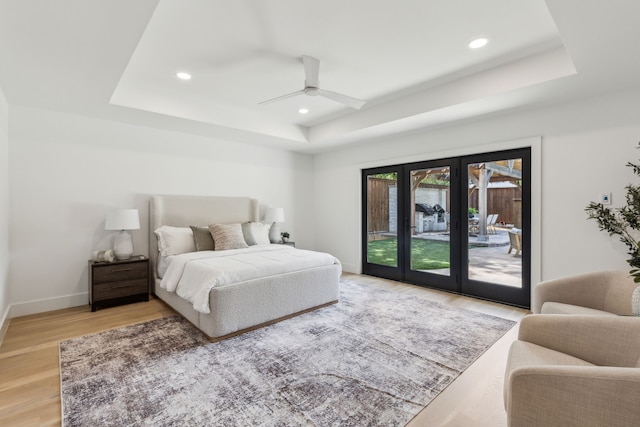 4162 Allencrest Ln, Dallas, TX 75244 - bedroom with a tray ceiling, access to exterior, recessed lighting, light wood-style floors, and baseboards