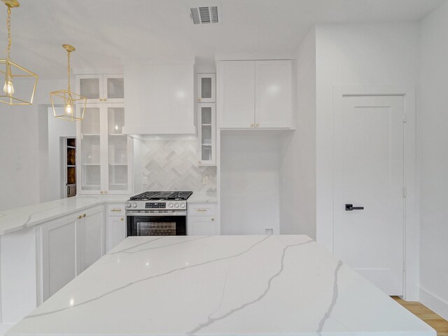 209 S Marlborough Ave, Dallas, TX 75208 - kitchen featuring gas stove, backsplash, white cabinets, glass insert cabinets, and light wood finished floors