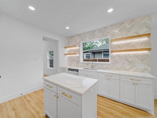 209 S Marlborough Ave, Dallas, TX 75208 - kitchen with open shelves, a sink, decorative backsplash, white cabinets, and light wood finished floors