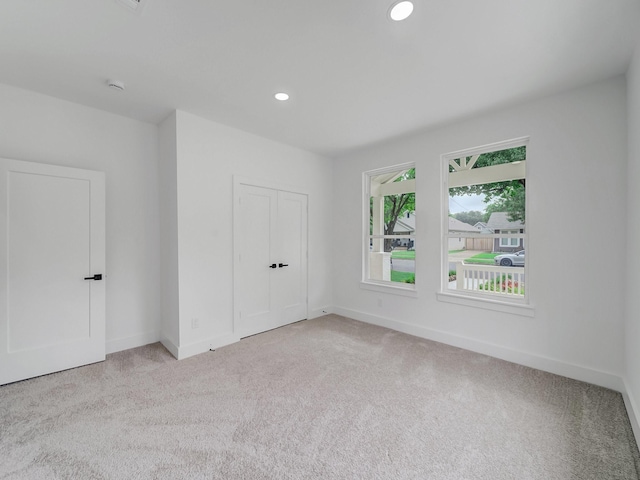 209 S Marlborough Ave, Dallas, TX 75208 - unfurnished bedroom featuring light carpet, baseboards, recessed lighting, and a closet