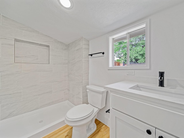 209 S Marlborough Ave, Dallas, TX 75208 - full bath with toilet, vanity, a textured ceiling, vaulted ceiling, and a tile shower